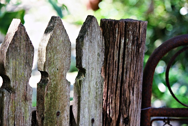 Metal hanging table near garden fence