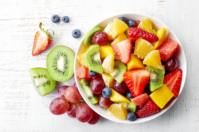 Colourful bird food mix in wooden bowl
